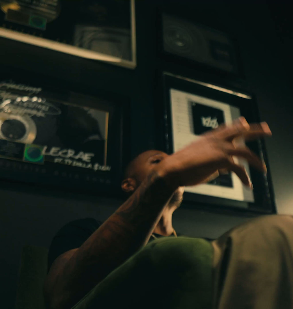 Lecrae at home under his plaques